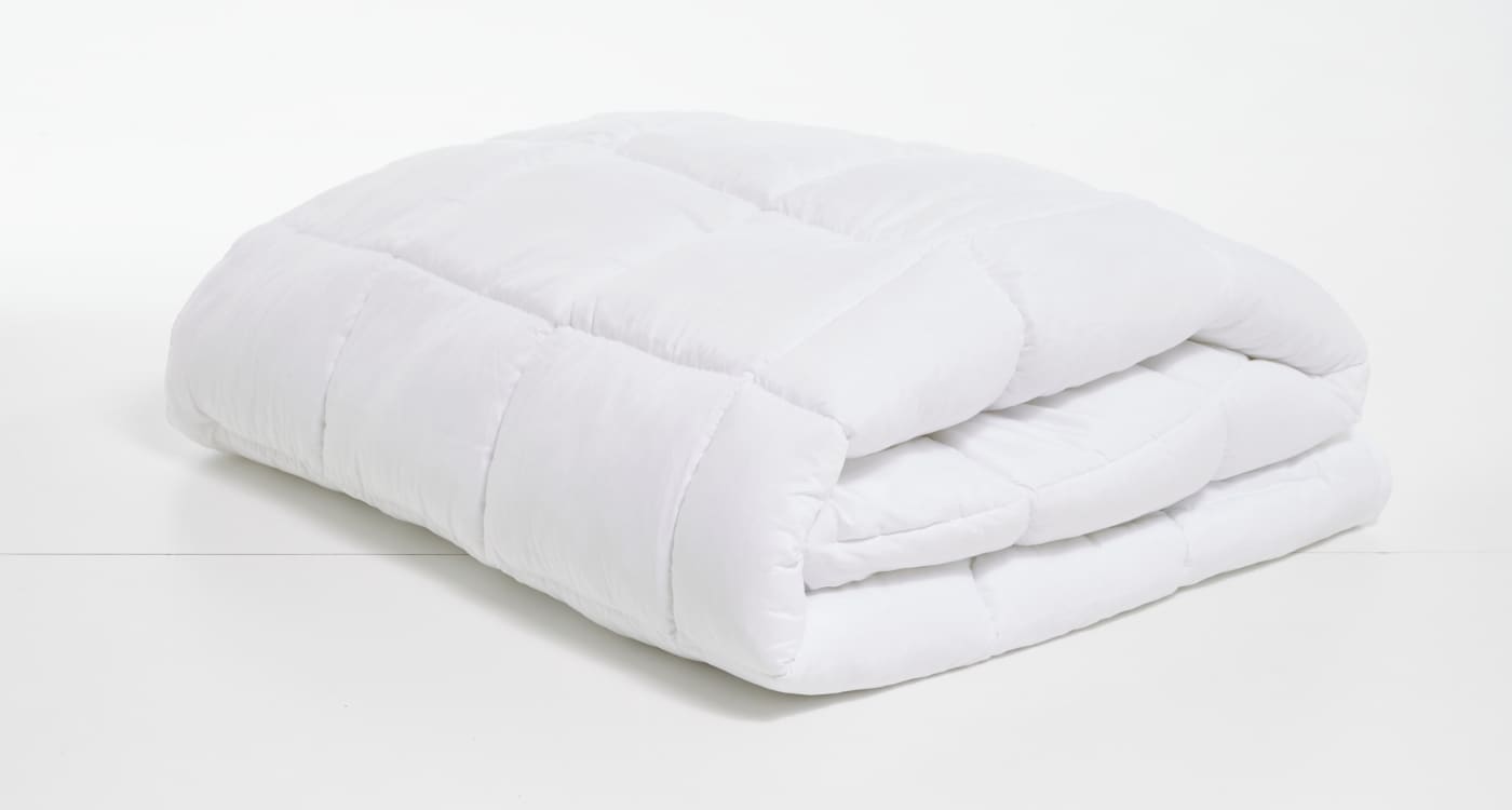 A cotton duvet inner displayed on a bed for the Manchester Duvet Inner Buying Guide