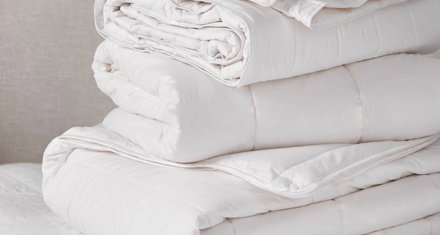 A feather and down duvet inner displayed on a bed for the Manchester Duvet Inner Buying Guide