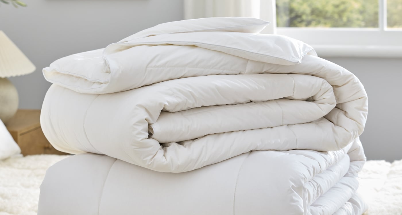 A wool duvet inner displayed on a bed for the Manchester Duvet Inner Buying Guide