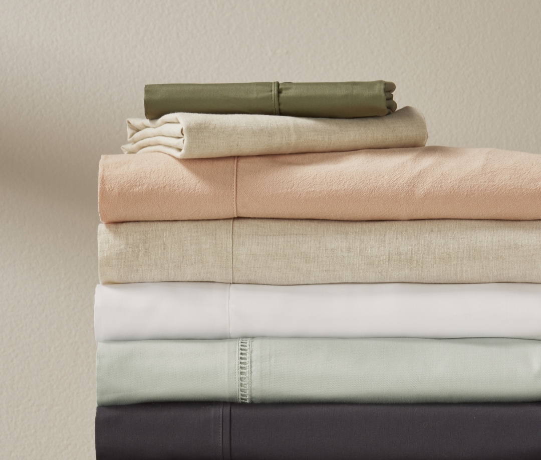 A selection of bed sheets displayed on a bed for the Manchester Sheets Buying Guide