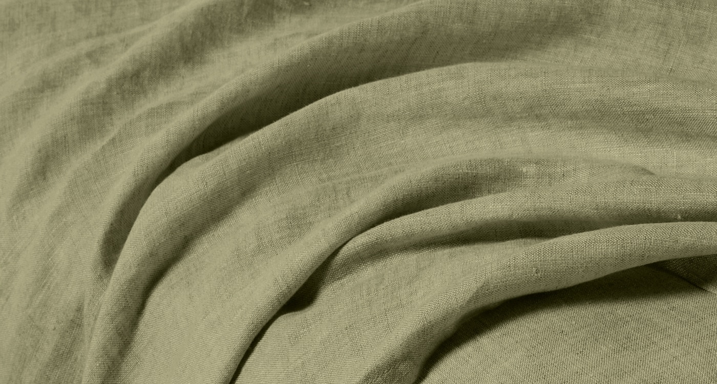 A linen sheet set displayed on a bed for the Manchester Sheets Buying Guide