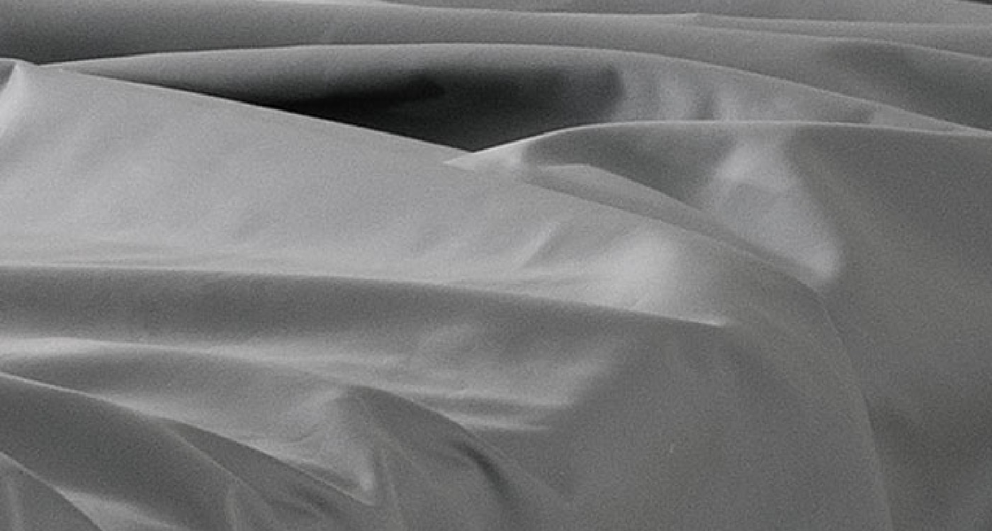 An Egyptian cotton sheet set displayed on a bed for the Manchester Sheets Buying Guide